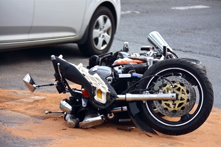 Motorcycle tipped over on sand in an accident